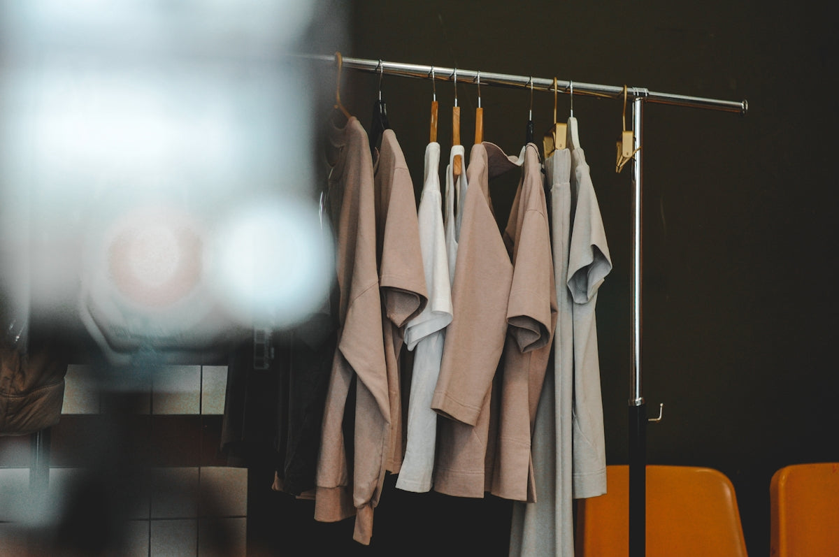 Clothes hang on a rack in a minimalist style.