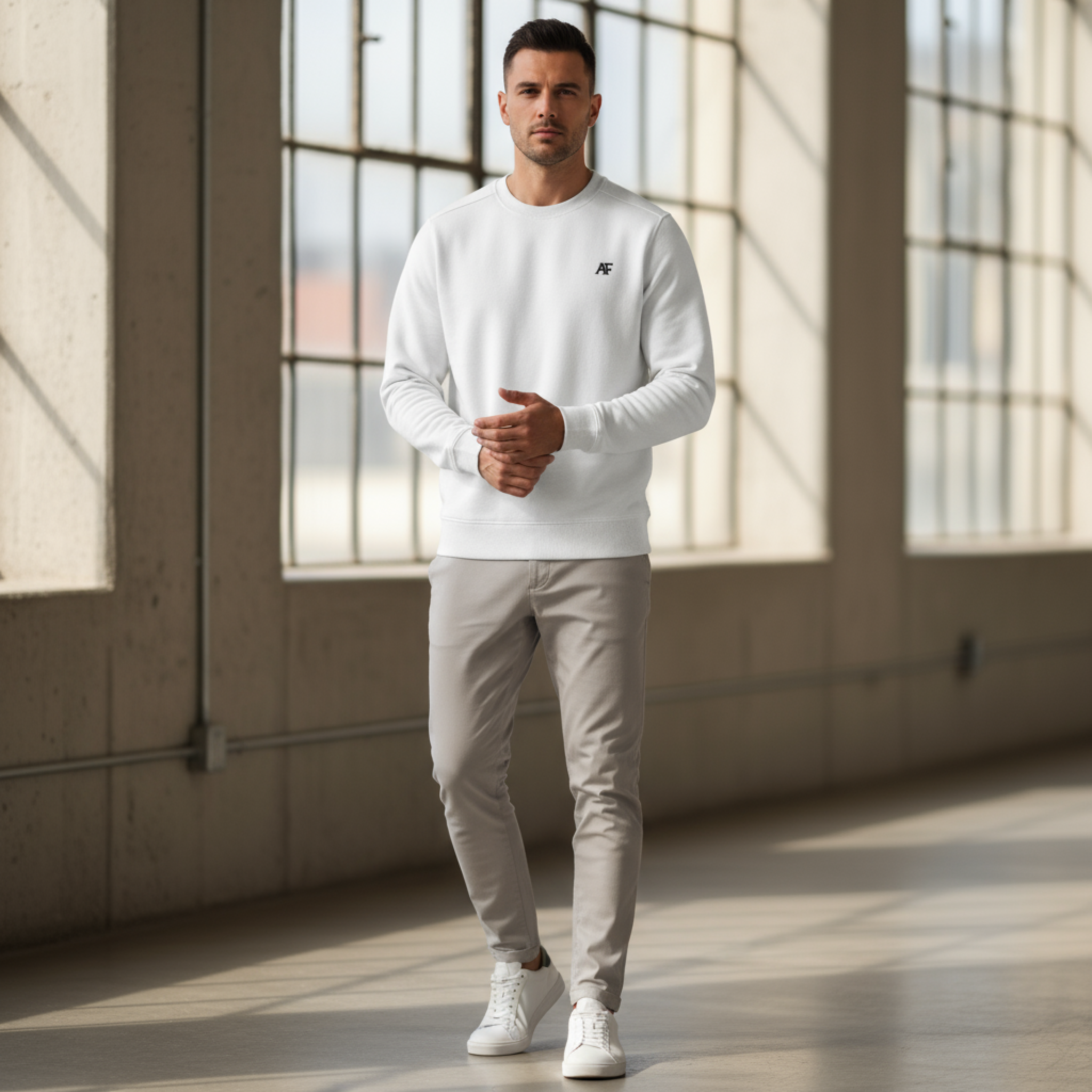 Atlas Form The Helios Crew in white, minimalist recycled-fleece crewneck sweatshirt with black AF logo on the left chest, worn in a modern gym or street setting with focus on the sweatshirt.