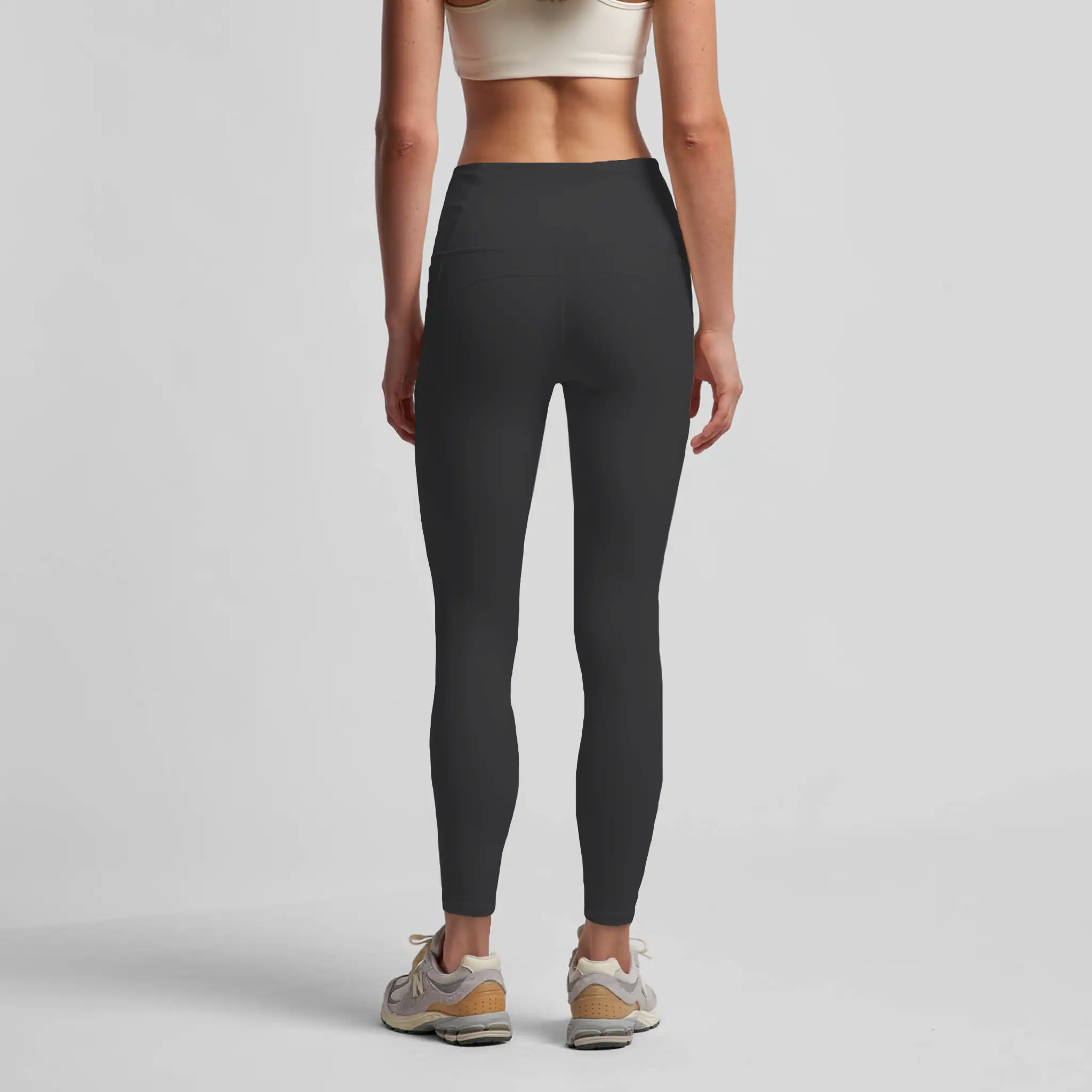 Person wearing black  Aphrodite leggings on a light gray background